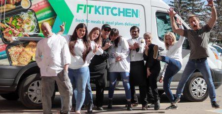 Fit Kitchen team posing in front of the company Van